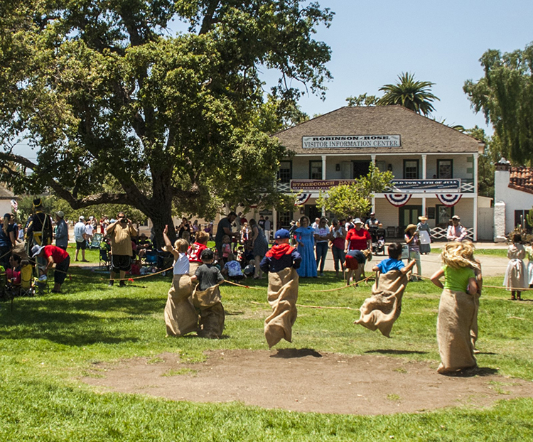 Visitors hop, leap, and dash toward the finish line during spirited 19th-century games at the 2019 Fourth of July event in Old Town San Diego SHP. Photo from California State Parks